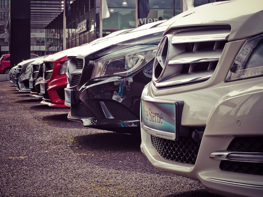 pexels-photo-164634-164634-3 Luxury cars lined up at an outdoor dealership, showcasing sleek designs.