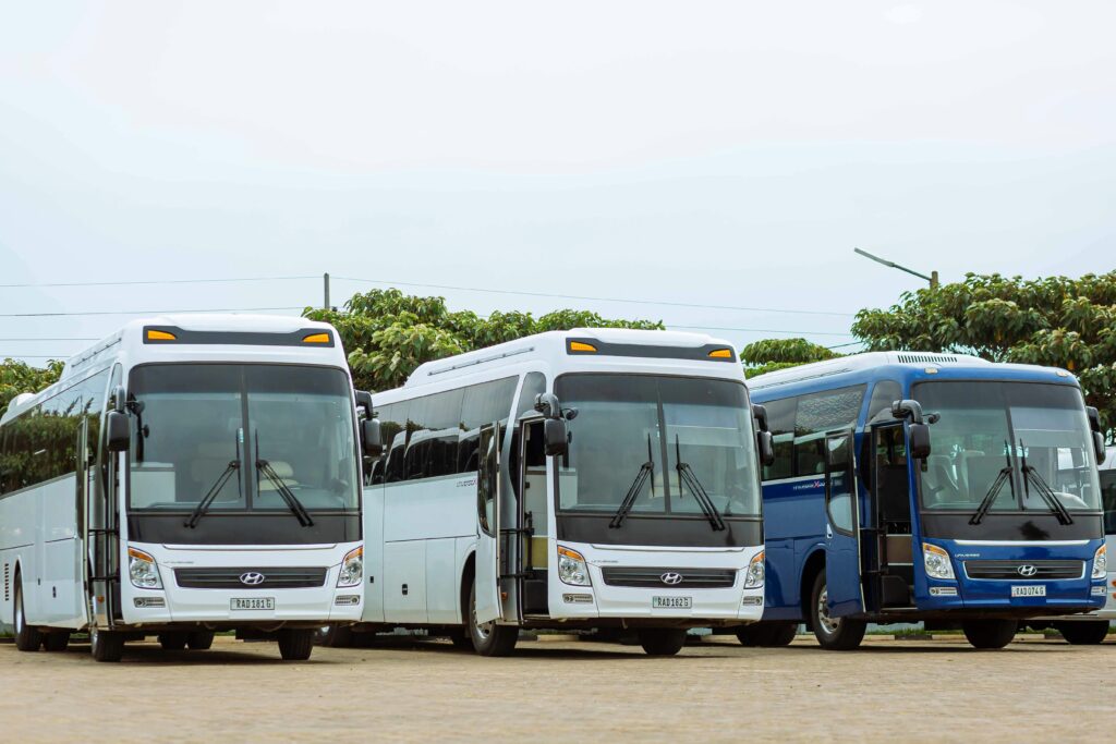 pexels-photo-18029643-18029643 Three Hyundai buses parked in an outdoor parking lot on a clear day.